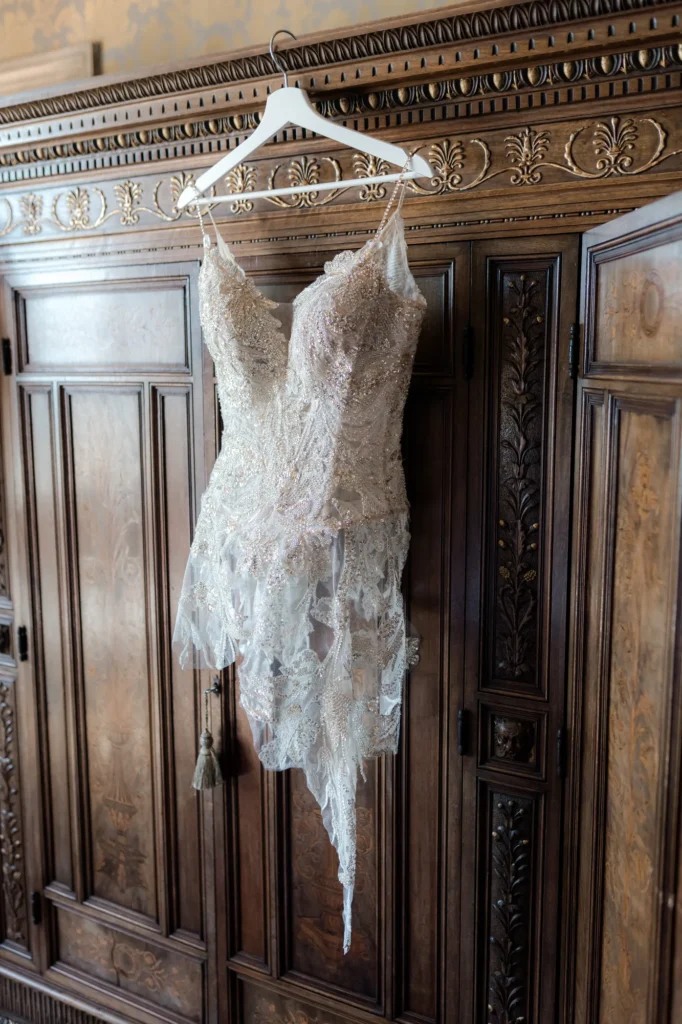 Wedding dress hanging on an antique wardrobe, Torre San Marco, Lake Garda