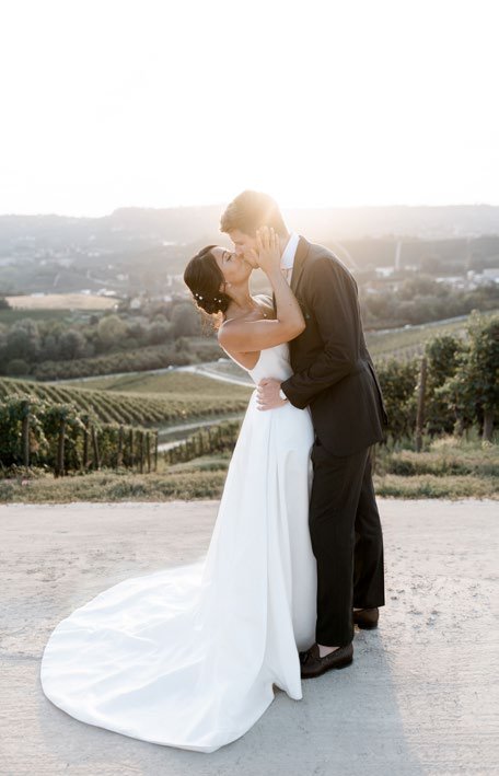 The couple kissing among the hills