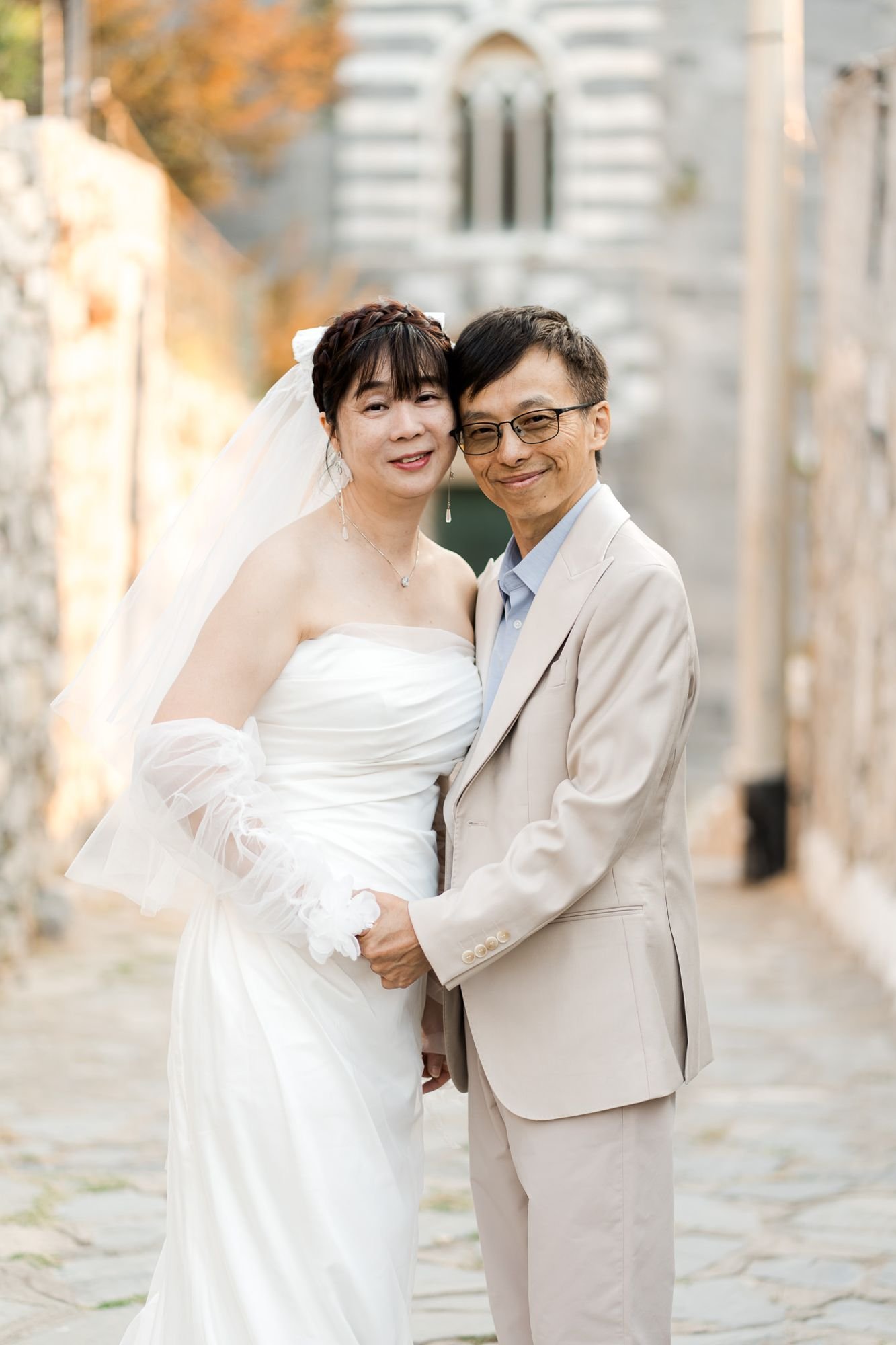 Erica and Lam smiling in front of an old church in Portovenere
