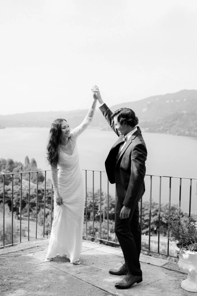 The couple dancing on a terrace above the lake